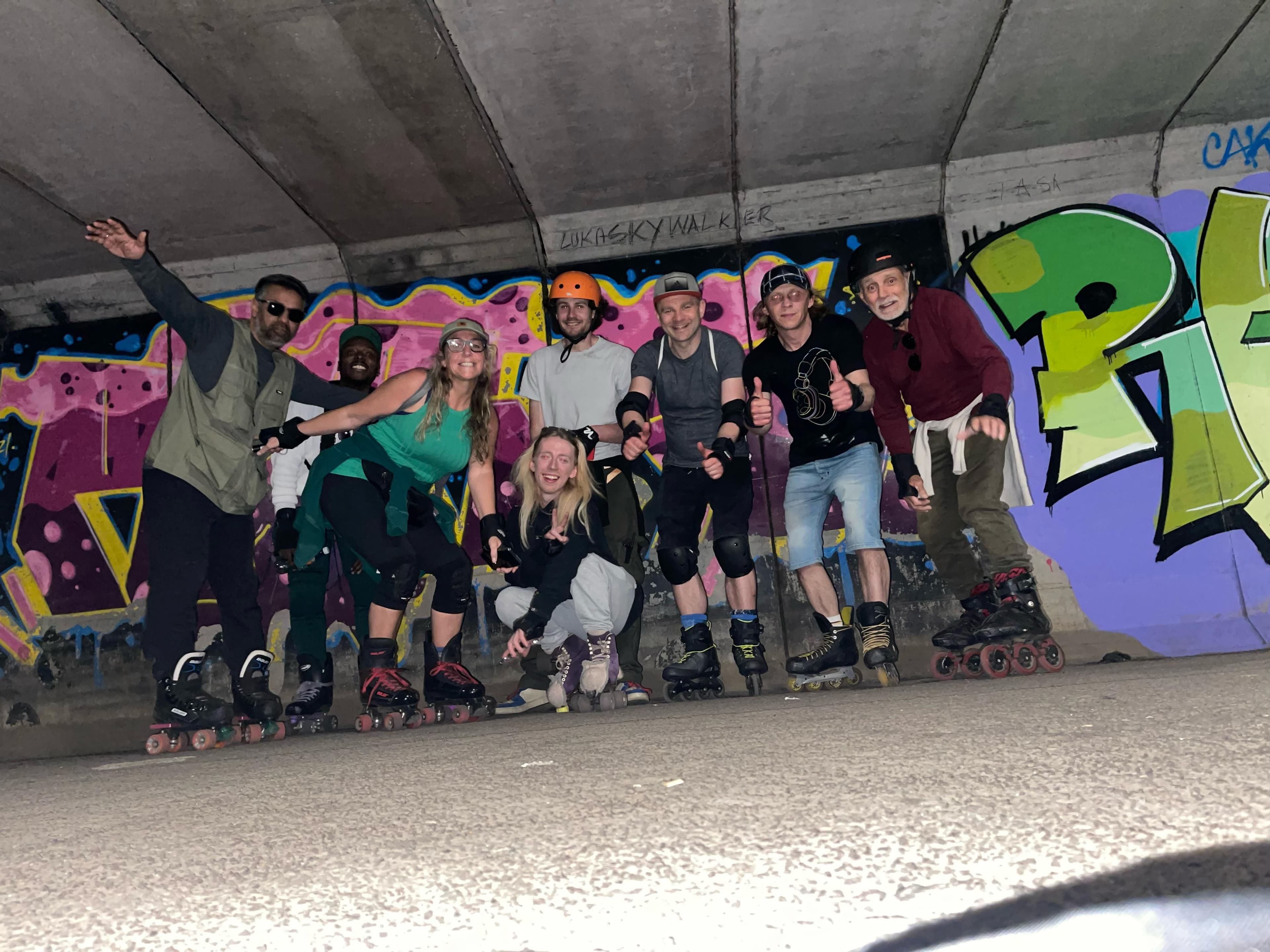 The sk8kind group in an underpass with graffiti